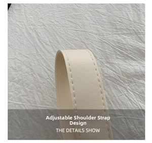 Detail of adjustable off-white synthetic leather shoulder strap with neat stitching