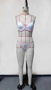Detailed view of light blue lace lingerie set with pink trim on mannequin display