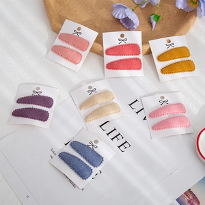 Close-up of assorted cashmere-like teardrop hair clips on cards for children and toddlers