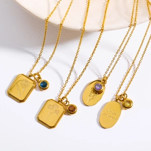 Detailed view of gold stainless steel necklaces with floral engravings and July Larkspur charm