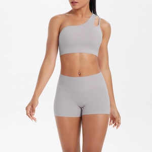 Detail of light grey one-shoulder sports bra and high-waist yoga shorts set for women