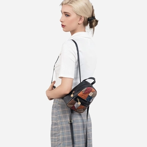 Chic women's plaid leather backpack shown by model from a side view in studio