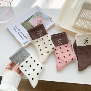 Set of four Japanese style mid-calf socks with polka dots and bow patterns in pastel colors