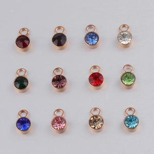Detailed grid showing 12 colorful crystal birthstone charms in round gold metal settings