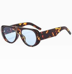Detail view of wide tortoise frame sunglasses with light blue lenses at 45-degree angle
