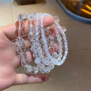 Macro detail of multi-layered clear quartz beaded bracelets showing crystal clarity