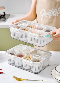 Close-up of clear storage box with inner draining baskets and manual date tracker lid