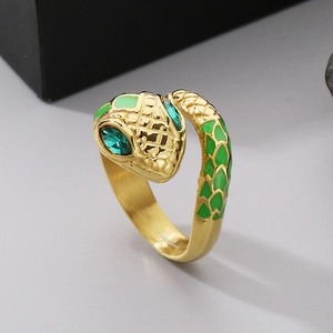 Macro detail of golden snake ring showing green enamel scales and crystal eyes