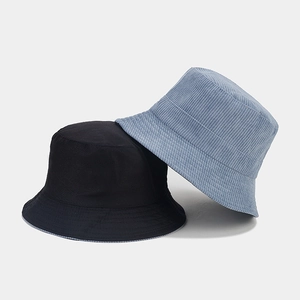 Double-sided corduroy bucket hat in black and light blue with a minimalist striped texture