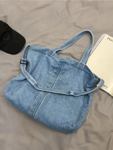 Vintage blue washed denim tote bag with dual handles and crossbody strap for daily casual use