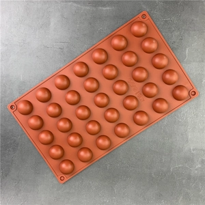 Brown semi-sphere silicone mold with multiple cavities for baking chocolate and mousse