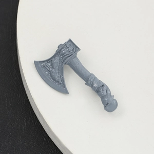 Vintage axe brooch with embossed texture on white tray against black background