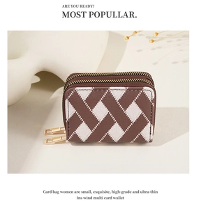 Detail view of double zipper card holder with brown and cream diamond lattice pattern