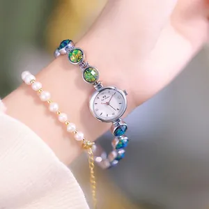 Silver bracelet watch for women with colorful opal inlays and pearl accessory