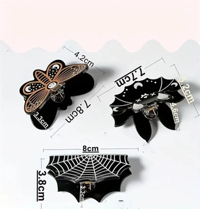 Detail of Halloween hair claws featuring moth, bat, and spider web designs with dimensions