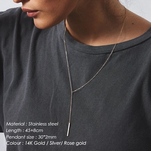 Minimalist stainless steel Y-necklace with long bar pendant in 14K gold finish on model