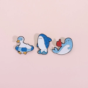Cartoon shark seal and duck enamel pins set featuring ocean animal badges on pink background