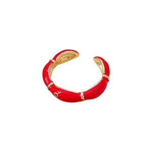 Gold plated oval open ring with red enamel bamboo design and glossy metallic finish