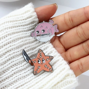 Funny ocean animal enamel pins set with pufferfish and starfish holding knives on sweater