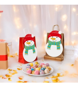 Close-up of a festive Christmas paper gift bag featuring a 3D snowman with a Merry Christmas hat