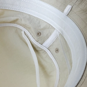 Detail view of quick-dry sun hat interior showing sweatband and breathable vent holes