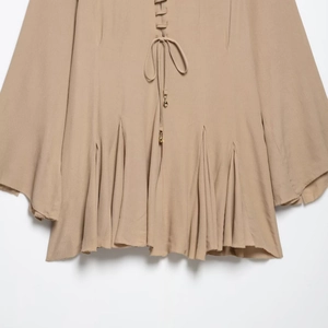 Elegant beige chiffon dress with drawstring waist and delicate pleated skirt detail