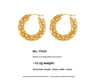 Detail of 34mm gold stainless steel hoop earrings with textured scale pattern surface