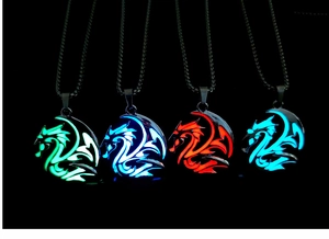 Luminous dragon pendant necklaces glowing in green, blue and red on metal chains