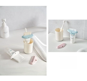 Close-up of manual tube squeezer showing ABS plastic slot design for various toiletries