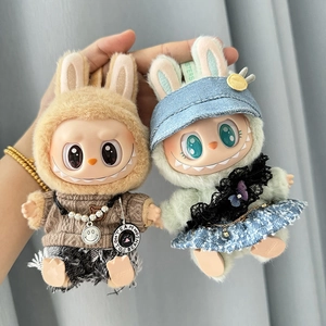 Close-up of brown hoodie with jeans and green hoodie with blue denim skirt for doll