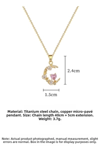 Detail of gold star and moon necklace with pink heart gem and sizing information