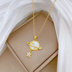 Elegant gold celestial planet necklace with white shell inlay and star pendant on silk