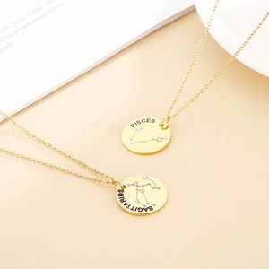 Detailed close-up of golden Pisces and Sagittarius zodiac pendants with rhinestones
