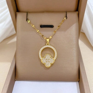 Close-up of gold-plated titanium clover necklace with sparkling cubic zirconia inlay