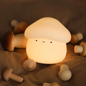 Cute mushroom silicone night light with warm yellow glow and adorable facial expression