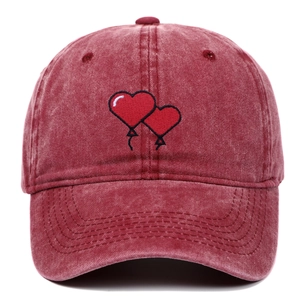 Vintage washed red cotton baseball cap featuring embroidered heart balloon design