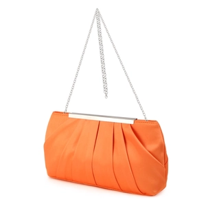 Detailed close-up of orange pleated satin evening bag with silver metal frame and chain