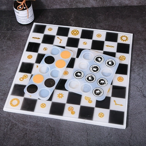 Close-up of translucent chess silicone molds with finished crown patterned resin pieces