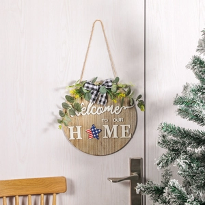 Rustic wood round Welcome To Our Home door sign with USA flag star and greenery decor