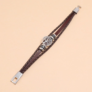 Detail of multi-layer woven brown leather bracelet with silver tree of life charm