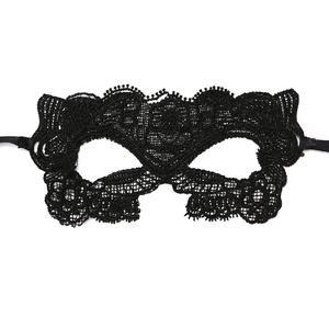 Close-up of black lace masquerade mask with intricate floral hollow out patterns