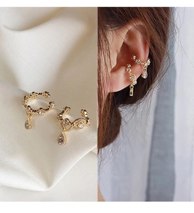 Detail of 14k gold clip-on earrings featuring sparkling teardrop zircon drops for women