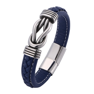 Detail of blue braided leather bracelet featuring a silver metal knot and magnetic clasp