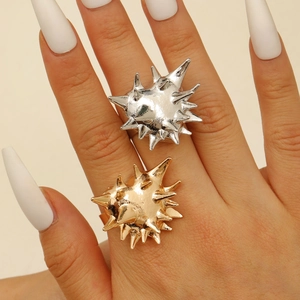 Detailed view of punk style punk sea urchin spiked rings in gold and silver finish