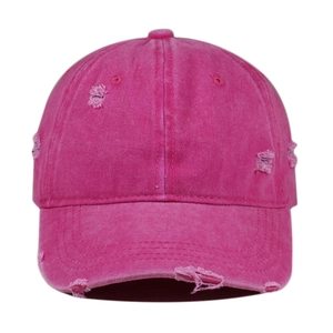 Close-up of distressed rose pink baseball cap with vintage washed fabric and ripped details