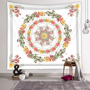 Floral mandala tapestry wall hanging with pink flowers on a minimalist brick wall background