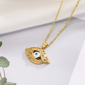 Detailed shot of golden Evil Eye pendant with colorful crystals on a stylish gold necklace