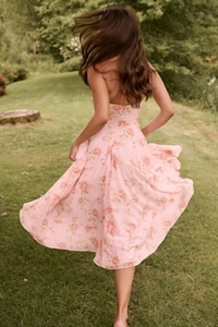 Detailed back view of flowy floral midi dress showing a halter neck and open back design