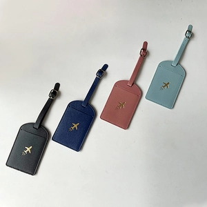 Set of four colorful PU leather luggage tags with gold airplane icons in four colors