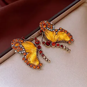 Luxury butterfly stud earrings with orange rhinestones and yellow glass wings